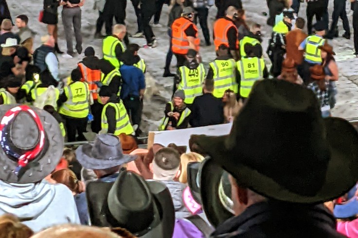 Large group of venue security in high vis waistcoats