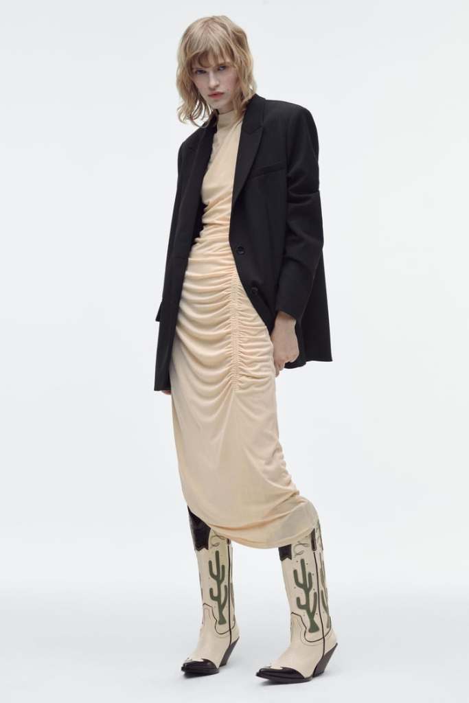 White boots wiht bloack contrast stitching and large green cactus shape on sides