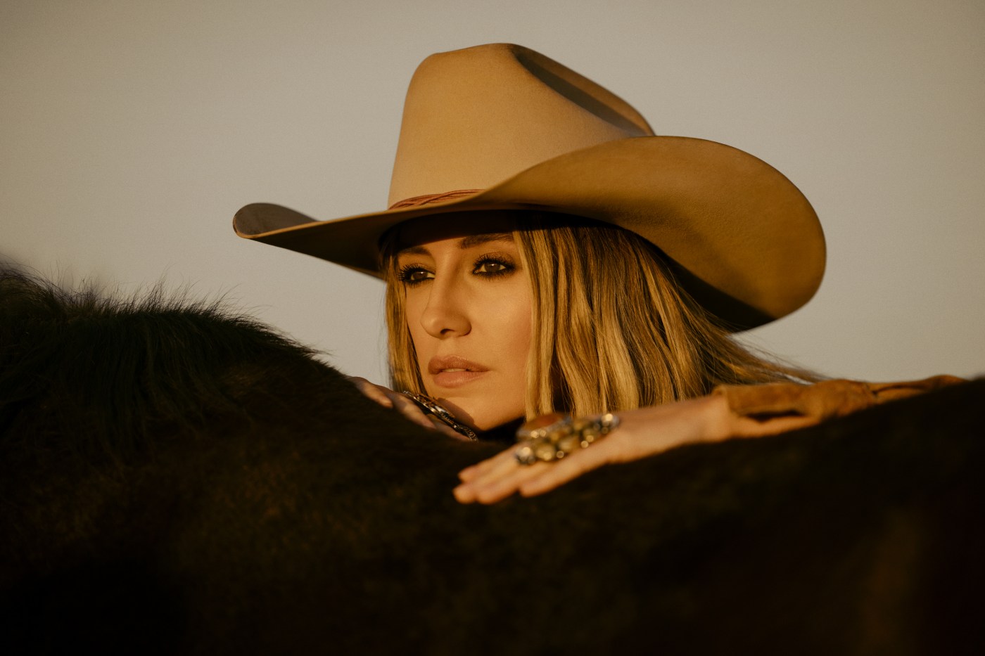 Head and shoulder shot of Lainey wilson in cowboy hat for cover of whirlwind
